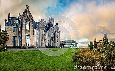 Stonefield Castle at sunset with bright green lawn in the front and some small bushes on the right in Argyll and Bute Scotland Stock Photo