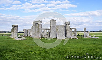 Stonehenge prehistoric monument, green grass, blue sky and clouds - Wiltshire, Salisbury, England Stock Photo
