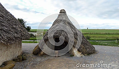 Stonehenge prehistoric monument, Stonehenge Neolithic Houses Exhibition, sunny afternoon - Salisbury, England Editorial Stock Photo