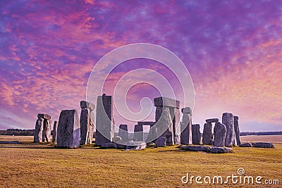 Stonehenge under dramatic sunset sky with long shadows Stock Photo