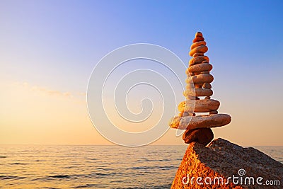 Stones balance on a background of sea sunset. Concept of harmony Stock Photo