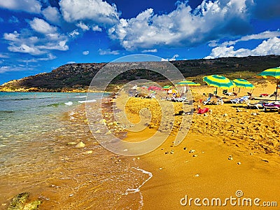 Stones beach with sea and mountain views. City beach during full summer season. Fisheye look. Sunny day at the beach Stock Photo