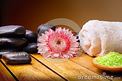 Stones flower towel and bath salts with brown gradient backgroun Stock Photo