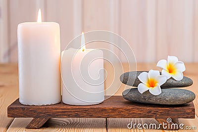 Stones for massage and frangipani flowers in composition Stock Photo