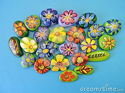 Stones with painted flowers and leaves Stock Photo