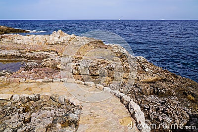 Stones pathway in rocks access to beach sea in coast Juan-les-Pins in Antibes France Stock Photo