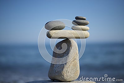 Stones pile background. Scales balance. Balanced stones on the top of boulder. Decide problem. To weight pros and cons. Stock Photo