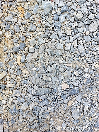 Stones on road surface - gray material on sand Stock Photo