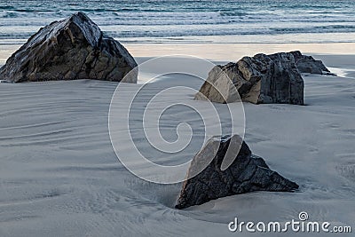 Stones on the snowy beach, long exposure at Lofoten islands, Norway. Stock Photo