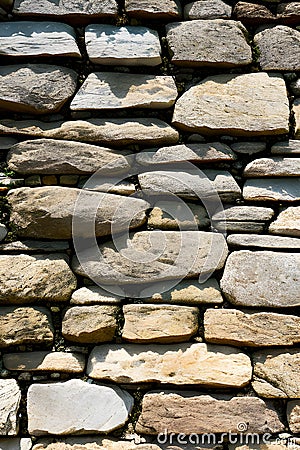 Stonewall with weathered surfaces with moss generated by ai Stock Photo