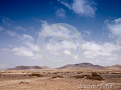Stony desert and distant mountains Stock Photo