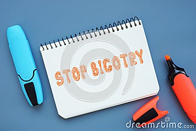 STOP BIGOTRY inscription on the piece of paper Stock Photo