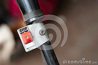 The stop button is red. Ignition button on the handle of the walk-behind tractor Stock Photo