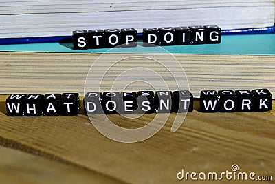 Stop doing what doesn`t work on wooden blocks. Motivation and inspiration concept. Stock Photo