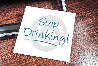 Stop Drinking Reminder On Paper On Wooden Cupboard Stock Photo