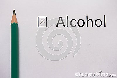 Stop drinking. word ALCOHOL is written on white paper with cross and pencil. Stock Photo