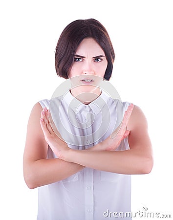 Stop gesture with indignation shown by a young woman in elegant clothes, isolated on a white background. A beautiful girl says no. Stock Photo