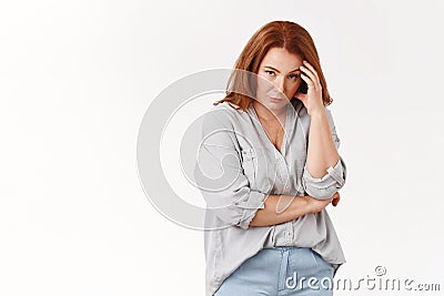 Stop it. Irritated displeased annoyed redhead middle-aged pressured woman touch temple look from under forehead scorn Stock Photo