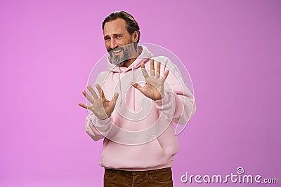 Stop no not come closer. Portrait awkward insecure afraid mature bearded man asking stop enough showing palms raised Stock Photo