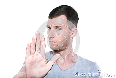Stop please! Young man gestures palm towards you Stock Photo