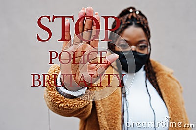 Stop police brutality. African american woman, wear black face mask show stop hand sign Stock Photo