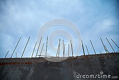 Stop. Prison. Protected location. Concrete wall with metal pins. Private property. Dark stormy sky. Copy space for text Stock Photo