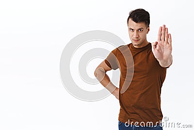 Stop right there. Portrait of serious confident young strong man show timeout, enough or no gesture, time is up Stock Photo