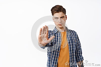 Stop. Serious and confident man restrain, say back off, no gesture, frowning and rejecting something, make keep away Stock Photo