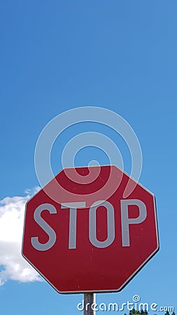 Stop sign on a clear blue skye background Stock Photo