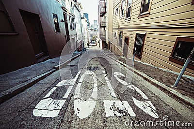 Stop sign on scenic asphalt road in residential areal of San Francisco. Stock Photo