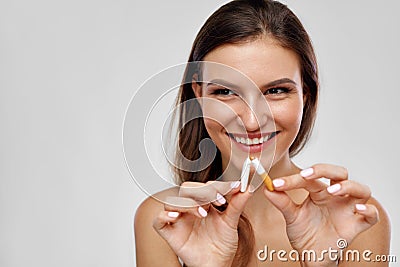 Stop Smoking. Beautiful Woman Breaking Cigarette In Half Stock Photo