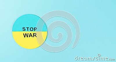 STOP WAR. Cardboard circle with Ukrainian flag and Stop war message. Copy space Stock Photo