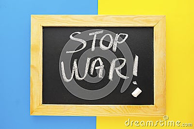 Stop War in Ukraine words on chalckboard frame. Ukraine blue and yellow flag Stock Photo