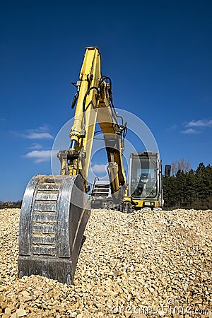 stopped Yellow excavator at the construction site. Stock Photo