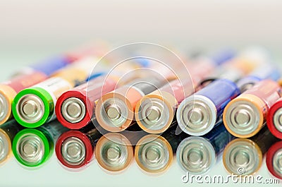 Storage batteries in rows. Closeup of pile of used alkaline batteries Stock Photo