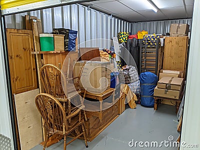 Self storage unit clearance packing furniture into room Stock Photo