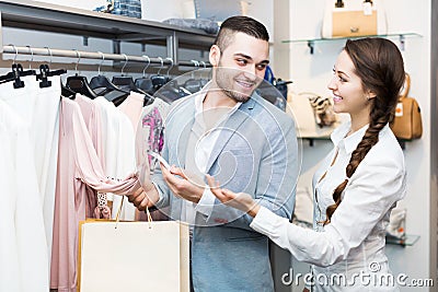 Store clerk serving purchaser Stock Photo