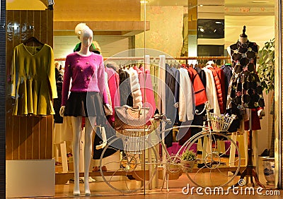 Store display window Light and decorative bike, Fashion boutique display window with mannequins, store sale window, front of shop Stock Photo