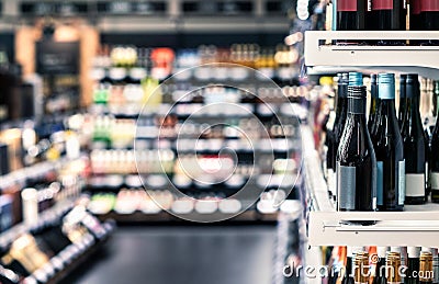 Store for liquor and alcohol. Sparkling wine bottle for sale in shop. Shelf and aisle in background. Stock Photo
