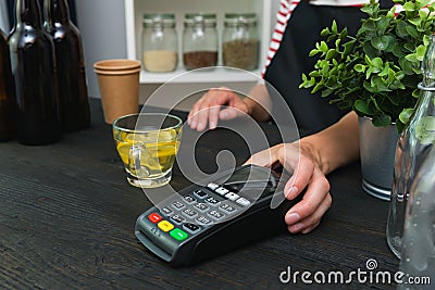 Store worker requesting for payment over nfc technology. Store worker holding pos terminal Stock Photo