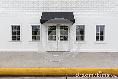 Storefront building with black awning Stock Photo