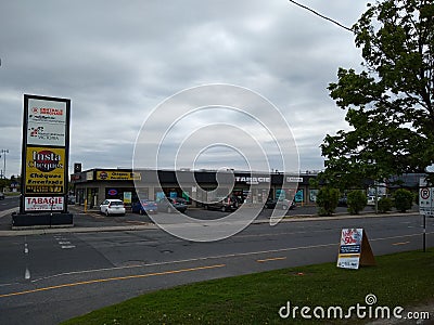 Stores viewed from across the street in Greenfield Park, Longueuil, Quebec, Canada Editorial Stock Photo
