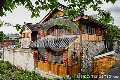 Storied tile-roofed timberwork buildings in cloudy spring after Stock Photo