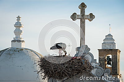 Stork nest and church towers church towers in Olhao, Portugal Stock Photo