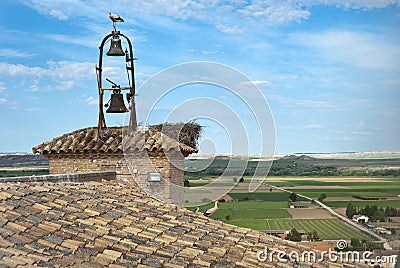 Storks on the bell tower of the church Stock Photo