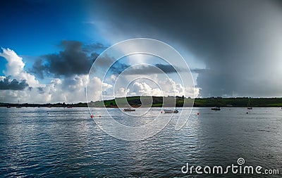 Storm approaching bay with boats moored in Youghal bay Ireland Stock Photo