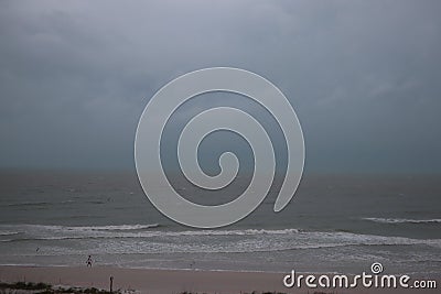 Storm on the beach. The seas are raging and the skies show the tropical storm as the power of nature is demonstrated. palm tree pu Stock Photo