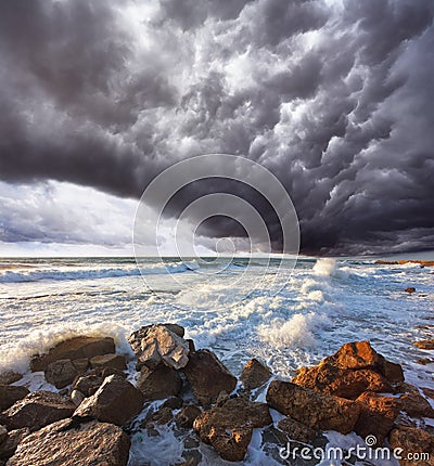 The storm cloud over the raging surf Stock Photo