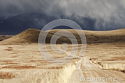 Storm Cloud Passing Through a Barren Mountain Land Stock Photo