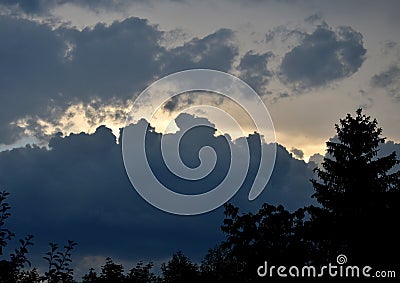 Storm clouds of fluffy puffy shape the beginning of a bubble-shaped thunderstorm, steel-gray color thunderstorm cell in the sky. h Stock Photo